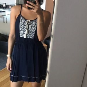 Navy blue dress with white embroidery.